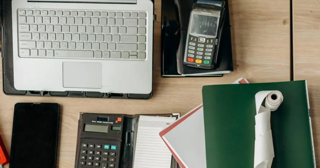 Bureau met laptop, calculator en documenten voor Snelstart boekhoudsoftware review